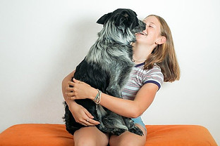 DO DOGS MAKE PEOPLE HAPPY? - girl hugging dog